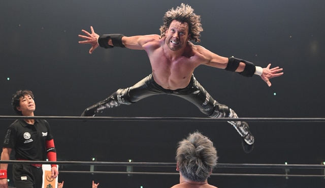 Kenny Omega in mid-air during an AEW match